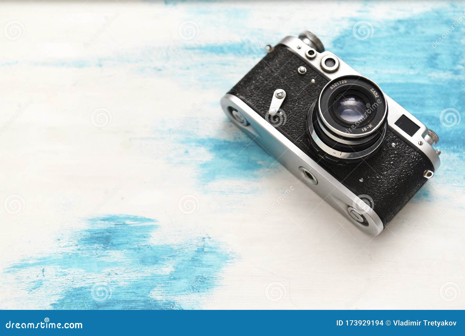 old camera on a painted wooden stand